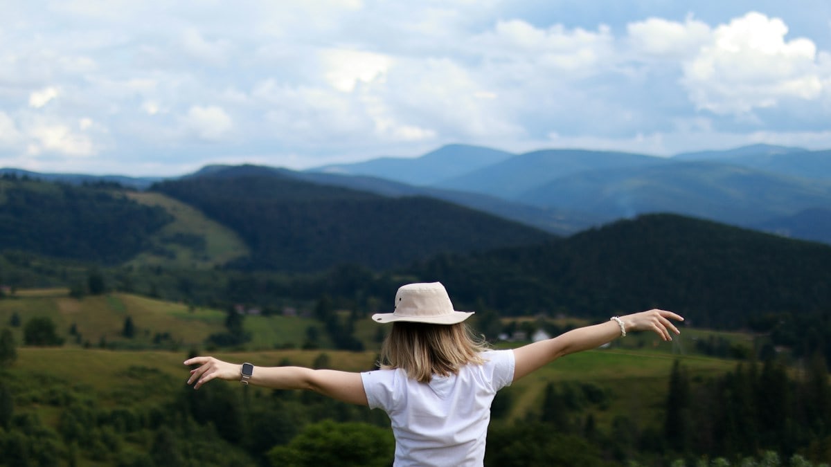 Happy woman high in the mountains
